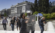 A demonstrator is confronted by the police during a protest of Greek teachers and students...