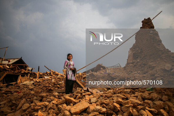 Parvati Sreshtha is standing on the rubbles where she lost her house due to earthquake. Kabrepalan Chowk, Nepal. May 6, 2015 
