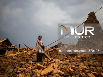 Parvati Sreshtha is standing on the rubbles where she lost her house due to earthquake. Kabrepalan Chowk, Nepal. May 6, 2015 (