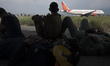 KATHAMNDU, NEPAL-- May 6, 2015--Indian Air Force helicopter officials wait in the shade of...