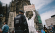 A policeman confronts with gas mask protester during the rally against coronavirus policy...