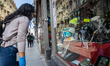 People looking the showcases of shops in Turin on May 18, 2020 during the country's lockd...
