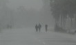 Residents walk along a street to a shelter ahead of the expected landfall of cyclone Ampha...
