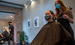 Cosmetologist Lillian Kappa cuts and styles customer’s hair at Parlour Salon as beauty sal...