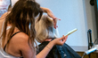 A cosmetologist styles a customer’s hair at Parlour Salon as beauty salons, barber shops a...