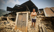 Santosh, 8 is standing in front of his destroyed house. Sindhupal Chowk, Nepal. May 7, 201...