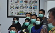 The team of medical personnel wearing masks brought two positive patients from the corona...