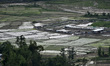 An aerial view of Nepalese farmers planting rice saplings during ongoing nationwide lockdo...