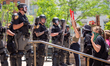 Hamilton County Sheriff deputies stand at the steps of the courthouse as protestors move c...