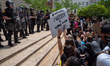 Hamilton County Sheriff deputies stand at the steps of the courthouse as protestors move c...
