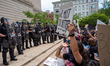 Hamilton County Sheriff deputies stand at the steps of the courthouse as protestors move c...