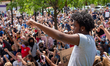 Protestors raise their hands during nine minutes of silence as demonstrators rally at the...