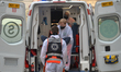 A team of paramedics lifts a patient into an ambulance in Krakow's Main Market Square. Si...