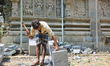 Worker chisels stone during re-construction of the Raja Gopuram tower of the Arul Eswari M...