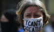 A participant of a march in memory of George Floyd wears a 'I Can't Breathe' protective ma...