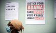 A placard reads 'Justice fro Adama, without justice  you'll never be in peace''. Several o...