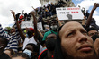 People raise their fists during a rally as part of the 'Black Lives Matter' worldwide prot...