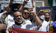 Community members stage a rally outside the Camden History Society during a Black Lives Ma...