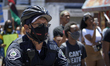 Police officers of the Camden County Police Department keep an eye out as demonstrators ta...
