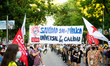 Protesters hold a banner that reads "Health 100% universal and quality public" at a protes...