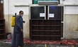 A man spray disinfectant in the mosque before opening them in front of worshipers, accordi...