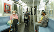 A person takes his scooter inside an MTA train in NYC as Manhattan enters Phase 2 of re-op...