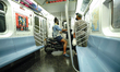 A person takes his scooter inside an MTA train in NYC as Manhattan enters Phase 2 of re-op...