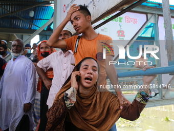 Relatives of a victim mourn after bodies recovered as a ferry capsized in Buriganga River at Sadarghat Launch terminal in Dhaka, Bangladesh...