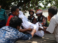 Rescuer workers carry body of a victim after a ferry capsized at Sadarghat Launch terminal in Dhaka, Bangladesh on June 29, 2020. At least 3...