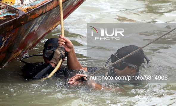 Rescue workers carry bodies of victims following the Launch capsized in Buriganga River in Dhaka, Bangladesh, on June 29, 2020. At least 30...