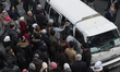 A group of people Wrestling to get a seat in the public transportation  in Damascus, Syria...