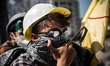 ISTANBUL, TURKEY--A protester wearing swim goggles and a construction helmet in Taksim Squ...