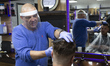  A man getting his hair cut at Mr Snips Barber Shop. Barbers' Shops and Hairdressers reope...