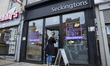   A lady waits outside Seckingtons' Hairdressers in Northampton, England, on July 4, 2020...
