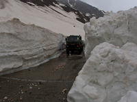 ZOJILA, INDIAN ADMINISTERED KASHMIR, INDIA - MAY 13: An Indian army vehicle passes through the snow-cleared Srinagar-Leh highway on a treach...