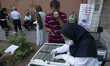 A laboratory staff wearing a protective face mask looking for a new coronavirus (COVID-19)...