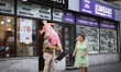 A man picks up a mannequin doll in front of a shop in central Warsaw, Poland on July 13, 2...