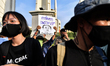 Pro-democracy displaying a placard during protesters calling for the Thai Prime Minister d...