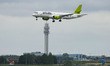Air Baltic Airbus A220-300 aircraft as seen on final approach flying, landing and touching...