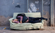 Beijing, China, the 8 June 2011. A man takes a nap on a sofa in the street. 