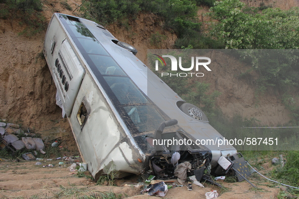 XIANYANG, May 15, 2015 () -- Photo taken on May 15, 2015 shows the accident site after a bus overturned and fell into a valley in Chunhua co...
