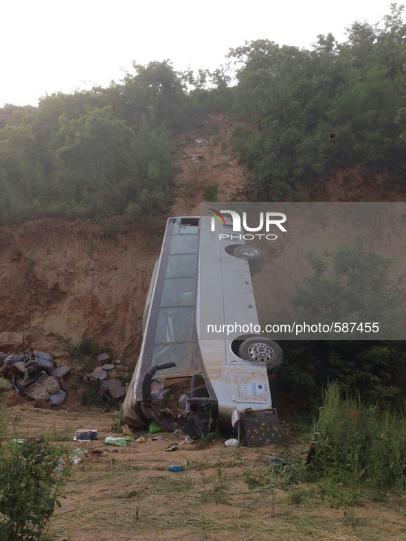 XIANYANG, May 15, 2015 () -- Photo taken on May 15, 2015 shows the accident site after a bus overturned and fell into a valley in Chunhua co...