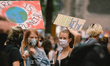 two protesters hold the placard ''there is no plan B'' and '' Fair return'' during the Fir...