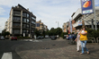 A woman carries a white rabbit on her hands through the street in Brussels, Belgium, July...