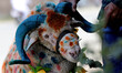 A customer looks at a sheep gathered by livestock vendors on a road ahead of the Muslim fe...