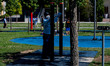 A park attendant from the Tree Library sanitizes the training equipment in Biblioteca degl...