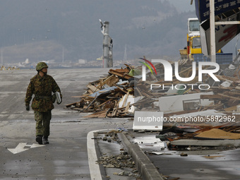 March 21, 2011-Ofunato, Japan-Military Officer check to state on debris and mud covered at Tsunami hit Destroyed Industrial Area in Ofunato...