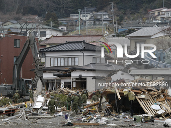 March 21, 2011-Ofunato, Japan-Military searching exhume body to debris and mud covered at Tsunami hit Destroyed Industrial Area in Ofunato o...