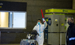 Chinese engineers arrive using protective biohazard suits to prevent the spread of novel C...