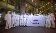 Chinese engineers arrive using protective biohazard suits to prevent the spread of novel C...